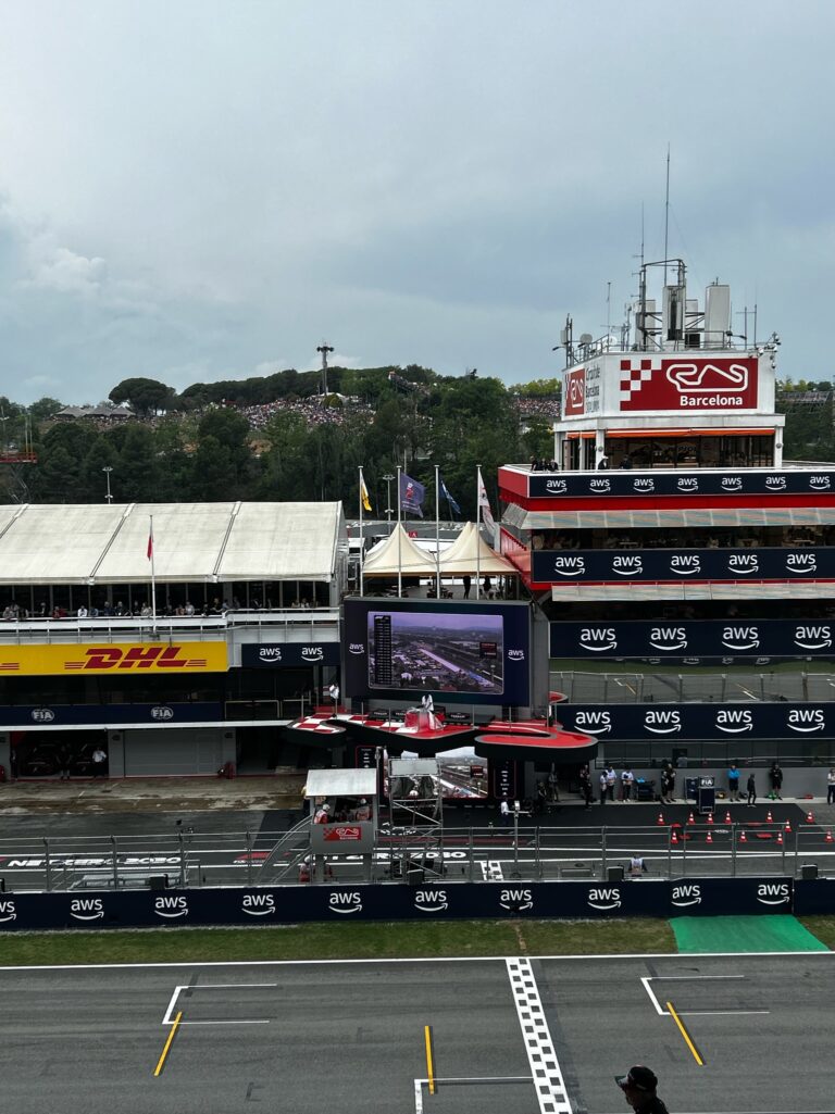 Barcelona Formula 1 circuit control tower and pit lane with checkered flag branding