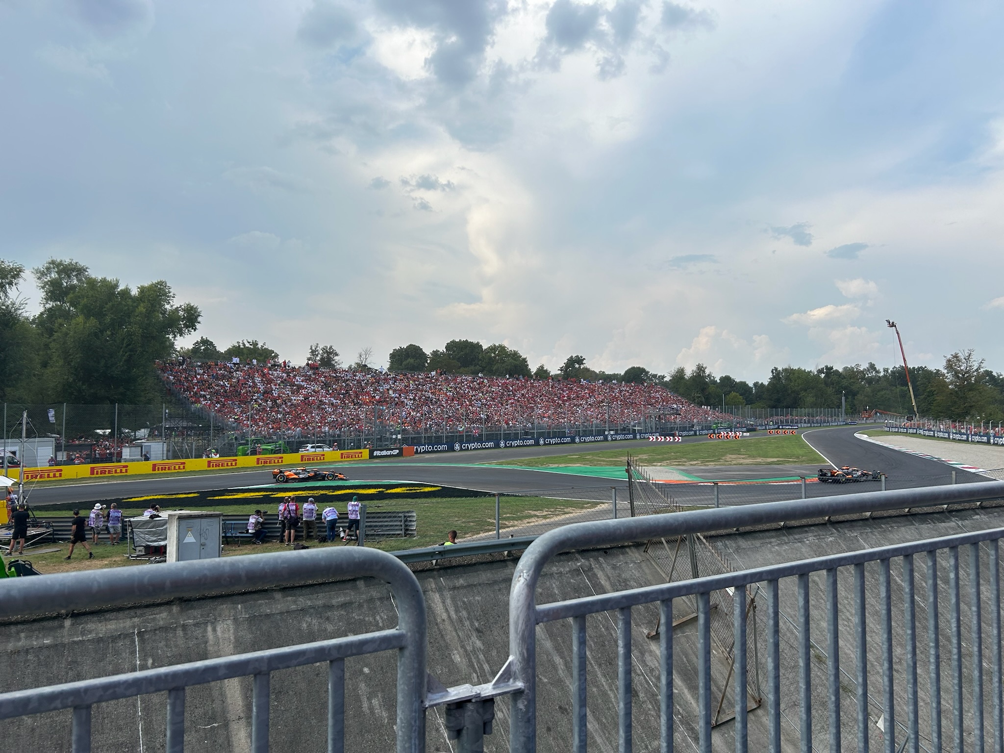 Cars stream past the grandstands at Monza on the day Leclerc won for Ferrari.