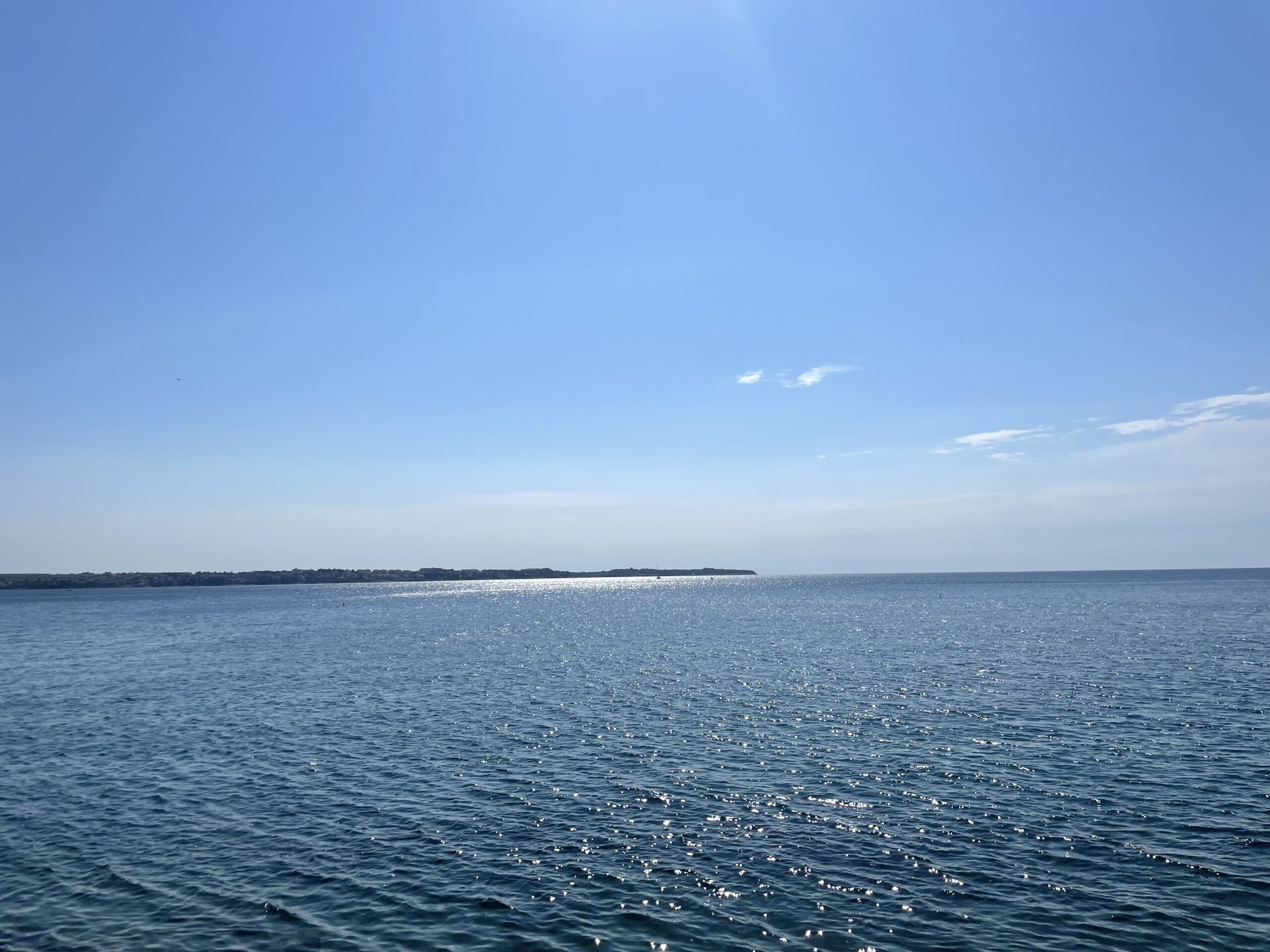 Panoramic view of the calm Adriatic Sea under blue sky