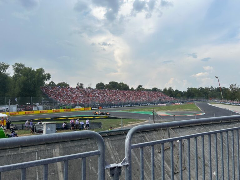 Tifosi grandstand at Monza Italian Grand Prix with Pirelli yellow walls and Parco di Monza trees